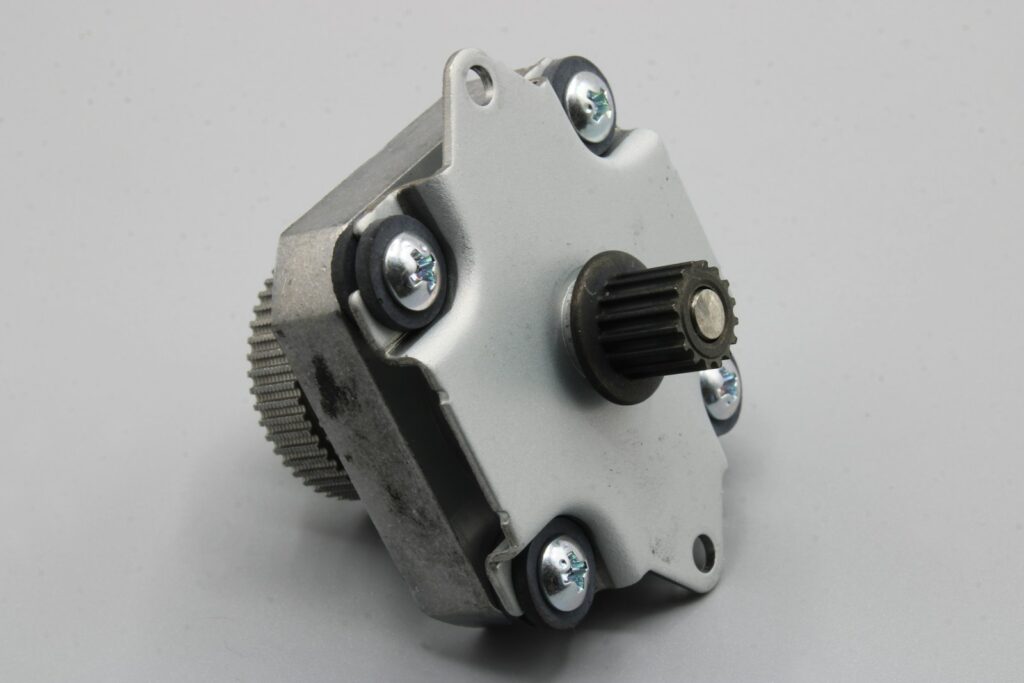 A close up of a metal object on a white surface